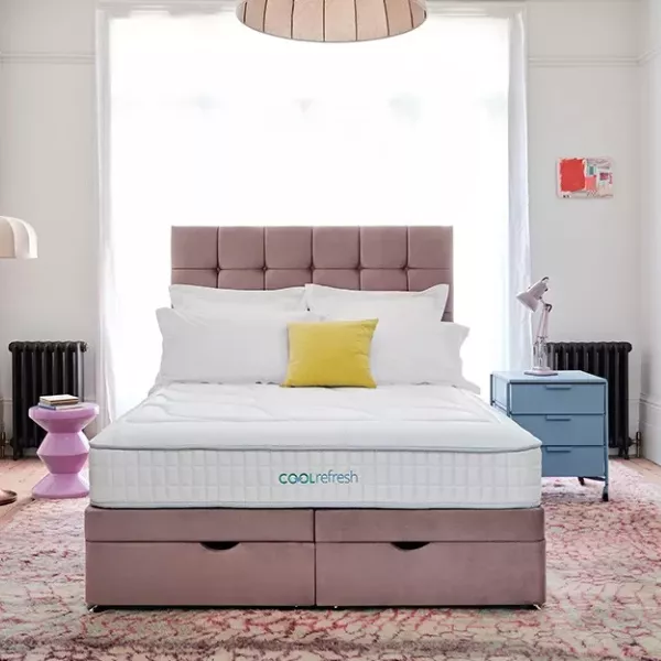 Beige velvet ottoman bed in a bedroom