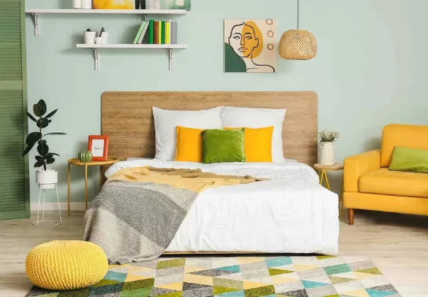 Colourful and modern bedroom with artwork, plants and bedside tables